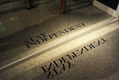 Floor decals were printed backwards so guests could read them in mirrors lining the entry.