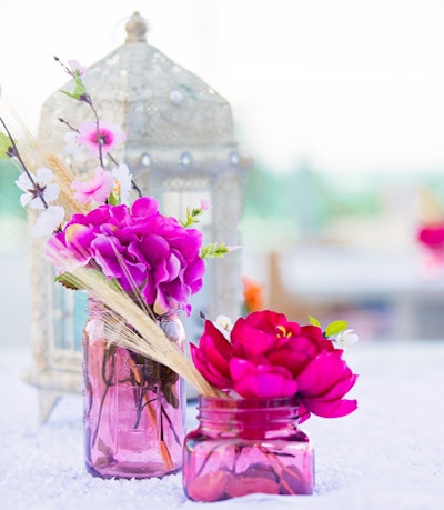 Tabletop accents included Moroccan-style lanterns and simple floral arrangements held in pink glass vessels.