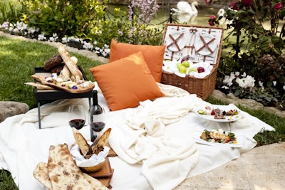Whether planners are looking to relax on the grounds or take a trip to one of Los Angeles' beaches, Hotel Bel-Air offers its signature picnic, complete with blanket, pillows, and table trays. The menu includes a la carte options such as grilled cheese, assorted charcuterie and salumi, tuna tartare, house-made soft pretzels, and chocolate-dipped strawberries. Approximate pricing for a three-course meal starts at $60 per person, with a set-up fee of $75 for each picnic. The picnics are set for two, but guests may contact the hotel for larger party requests. Call 310.472.1211 for more information.
