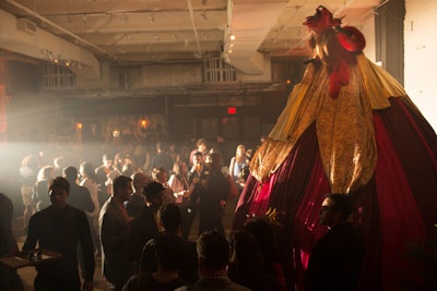 A woman perched on 25-foot stilts concealed an invite-only tea party under her costume.