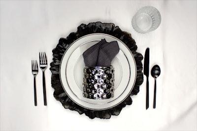 Black Sunburst glass charger, $5; charcoal linen napkin, $2.75, available throughout the East Coast from New England Country Rentals. Honeycomb pillar, $6; Platinum Rim Coupe dinner and lunch plates, $.90 each, available nationwide with delivery fees from Party Rental Ltd. Capri black matte flatware, $1.50 per piece, available in Atlanta, Charlotte and Raleigh, North Carolina, and throughout Northern and Southern California from Classic Party Rentals. Timeless rocks glass, price upon request, available in the mid-Atlantic region from All Occasions Party Rental.
