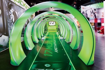 An illuminated tunnel was a budget-friendly way to make a highly visual impact at the 25,000-square-foot booth for TaylorMade-Adidas Golf at the P.G.A. Merchandise Show in 2012. The 51-foot green exhibit showed the distance golfers gain when they use brand's RocketBallz equipment.
