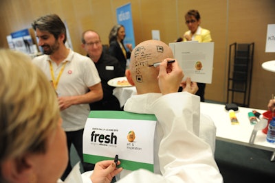 For a lighthearted spin on the art theme, conference organizer Maarten Vanneste got a complete shave and allowed artists to paint his head like the event logo.