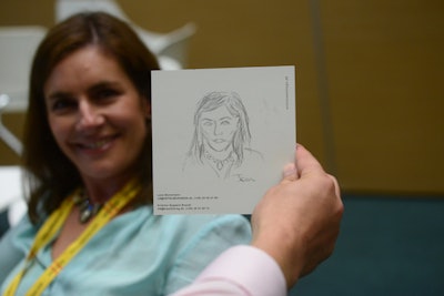 Artists from the Danish company Arts in Meetings sketched portraits of conference attendees.
