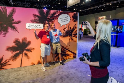 The lounge’s photo area includes a tropical backdrop and a variety of playful signs for guests to hold.