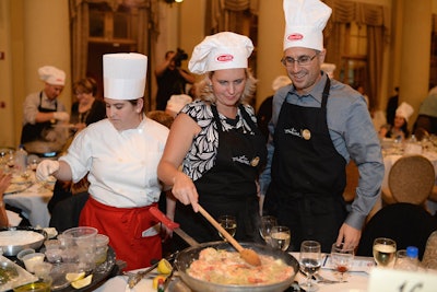 Using electric appliances, guests in logo chef hats participated in the Barilla cooking experience.