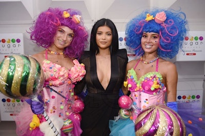 Celebrity host Kylie Jenner posed for pictures flanked by candy-bedecked entertainers at the event.