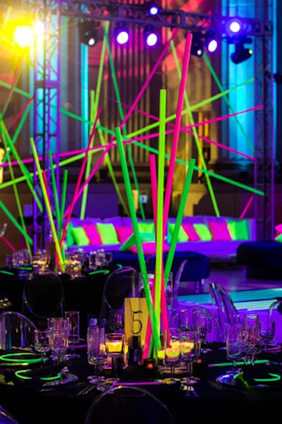 Neon rods served as table centerpieces. 'We wanted something that gave height, but we also wanted something that wasn't breaking the bank,' Evoke president Jodi Moraru said.