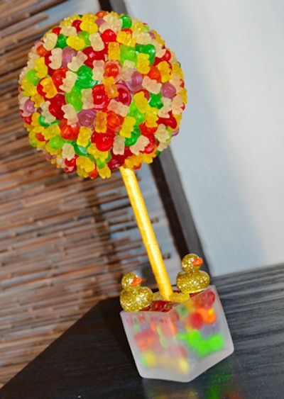 One topiary-like arrangement featured gummy bears. Overall there were 16 arrangements made out of candy on the bars and coffee tables.