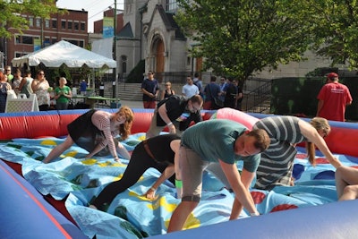 Chicago company Groupon uses nostalgic games—such as Twister—to bond employees at its annual summertime outing.