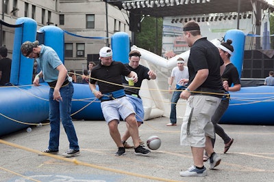Imaginative games included 'human foosball,' in which lines of employees looped together by string played a soccer-like game. Participants wore Groupon-branded headbands.