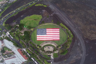 At its 2014 annual convention in Hawaii, La Quinta Inn & Suites set three Guinness World Records in 90 minutes as a teambuilding experience. Within 90 minutes, company employees set the records for largest towel mosaic—creating an American flag measuring more than 26,000 square feet—as well as the longest human towel chain and longest high-five chain, with more than 1,100 participants in each. All three records have since been broken.