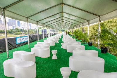 Kehoe Designs used white plastic lounge furniture on the deck of Lollapalooza's V.I.P. area in 2014; this year, the firm will debut new wicker furniture rentals.