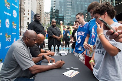 Former Philadelphia 76ers greats Moses Malone and World B. Free signed autographs for fans.