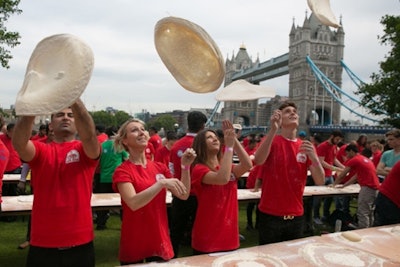 Papa John’s celebrated the company’s opening of its 300th store in the United Kingdom on June 26 with a record-setting stunt in London. The 338 participants broke the record for the most people tossing pizza dough at one time.