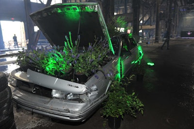 Later in the evening, spotlights lit up to reveal burnt-out cars and trucks with plants spilling out of them.