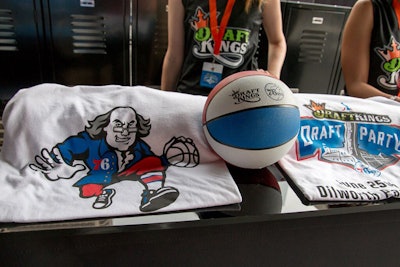T-shirts and basketballs with the new logo for the Philadelphia 76ers were part of a sports-theme space complete with lockers. The first 1,000 fans received free T-shirts.