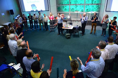 Following Samson’s performance, he invited attendees to stand and clap, moving from simple to more complex rhythms. Samson’s strategy is that people making music together are naturally drawn to one another, and when the activity is over they easily continue their conversations.