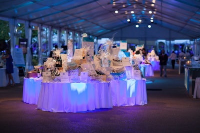 The silent-auction tables, which held prizes such as a reservation at Ralph Lauren's Polo Bar in New York, were internally illuminated with blue lights.