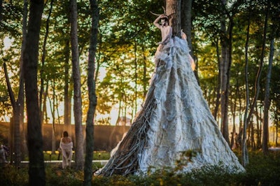 One of the night's most Instagrammed artworks, Adriana Dinulescu's 'Nature's Hot Spot' installation boasted a massive dress made of waxed paper and branches that wrapped around a tree with a lone performer placed inside the costume.