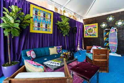 Brightly colored frames, pillows, drapes, and carpet filled the space.