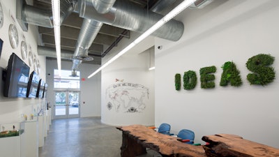 Long view of lobby, two photo studios on the left behind monitors.