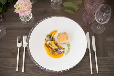 Seared sea bass with a spicy sweet pea purée, curried coconut, carrot purée, and local vegetables makes for a colorful entrée.