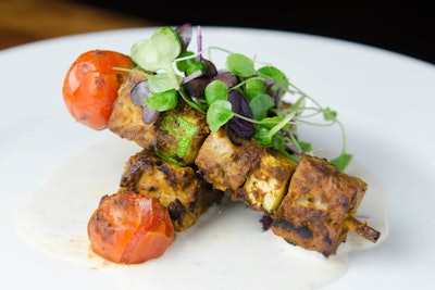 Grilled North African-spiced tempeh kebabs made with zucchini and cherry tomatoes, served with horseradish crème, by Blossom in New York