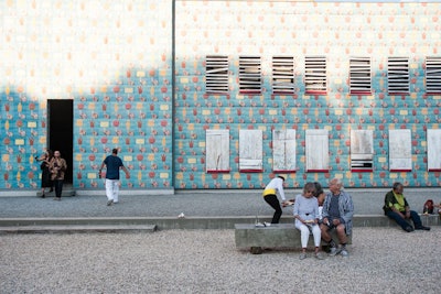 While in the past guests entered through the main building and out onto the courtyard, this year the edifice served purely as a canvas for art. Gary Garay's 'Paleta Wall' had the western façade of the building plastered with his posters—images of hands holding ice pops in the shapes of 40-ounce bottles, Westside hands, Amor Pura (Pure Love), a cassette, and Aztec head.