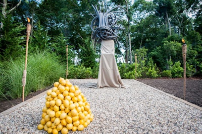 Once past the main entrance steps and right before the pathway to the Africa House sat two installations as part of Mette Sterre's 'Sweet Beans Constrictors' artwork. Atop the landing, the Dutch artist created a pair of headpieces from coiled and tied tubing, representing dramatic forms of negative space in which performances sat and gazed at guests. Piles of fruit, in keeping with the theme, were featured as a complement.