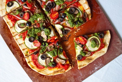 Grilled vegetable pesto pizza topped with mushrooms, zucchini, and grape tomatoes, by Leslie Durso in Los Angeles