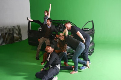 Attendees posed with a Honda in front of a green screen that made their photo session look like snaps from a road trip.