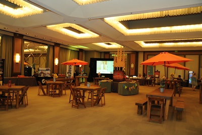 Furniture and decor in the conference hub, known as “One Place,” aligned with the camp theme. The room housed the registration area, sponsor booths, recharging stations, and snacks.