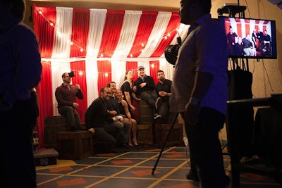 At the Groupon party, held at the Aragon Ballroom in December 2014, guests posed in front of a striped circus tent backdrop. The event was inspired by the Chicago World's Fair.