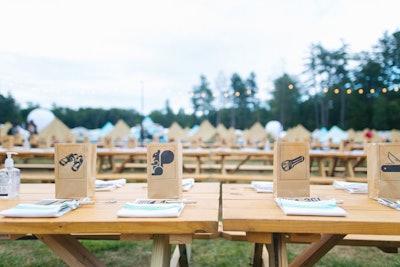 Images of animals and camping equipment decorated paper bags that housed candles on tables at dinner time.