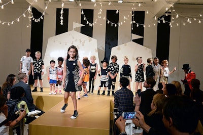 The runway set had circus tent silhouettes and bold black-and-white stripes.