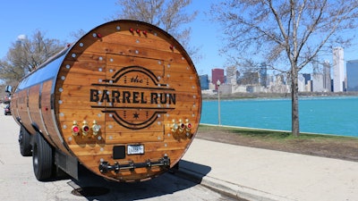 The wood staves, steel hoops, and curved shape represent the feeling of a real barrel