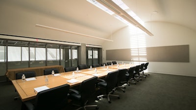 Sleek board room with natural light and built-in AV. Photo by Bebe Jacobs.