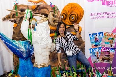 Some exhibitors created elaborate cakes to serve as a backdrop for photos in their booths.