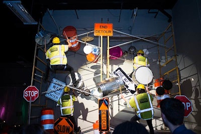 A percussion group dressed as construction workers used some unusual instruments to perform for guests at the Cirque du Soleil-inspired holiday party for Traffic Control Services, held at its corporate office in Hummelstown, Pennsylvania, in December 2014. The event was designed by Camp Hill, Pennsylvania-based catering and events company JDK Group.