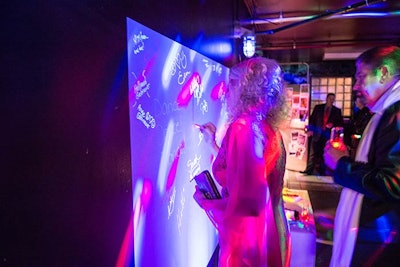 Guests signed a light graffiti wall at the Comcast Spotlight holiday party in November 2014. JDK Group produced the disco fete.