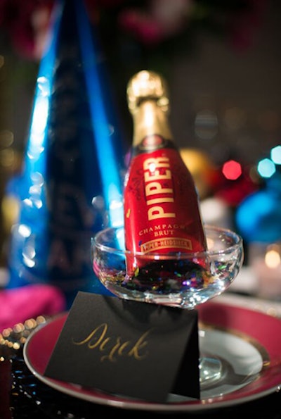 Individual bottles of champagne and place cards with calligraphed names by Arney Walker Calligraphy dress up each table setting.