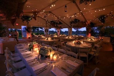 Levy Lighting used string lights to illuminate an outdoor tent at a private Labor Day party in East Hampton, New York.
