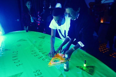At art nonprofit Creative Time's fall ball in November 2014, guests played with an oversize Ouija board from art collective and performance group FCKNLZ.