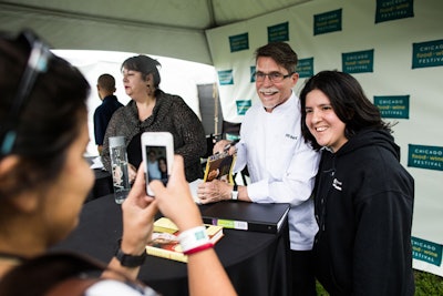 At a book-signing tent stationed near the festival's entrance, celebrity chefs such as Rick Bayless (pictured) signed cookbooks for fans. Earlier that day, Bayless had led a cooking demo dubbed 'Fiesta al Fresco' in the nearby Mulberry Demo Tent.