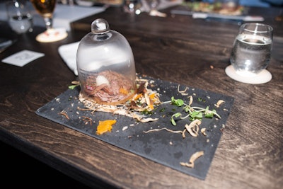 The course called 'Nature's Textures' has a 'bird's nest' made out of braised beef and served with caramelized cauliflower puree, mushroom leaves, salsify branches, succulent greens, and cauliflower soil. The dish was served under a glass dome that held the aroma of a campfire.