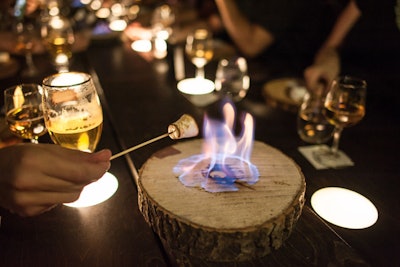 The final course, called 'Touch Light,' offered a modern take on s'mores. The dish put chocolate ganache and graham cracker bits inside of a marshmallow, and guests roasted their own desserts over open flames.