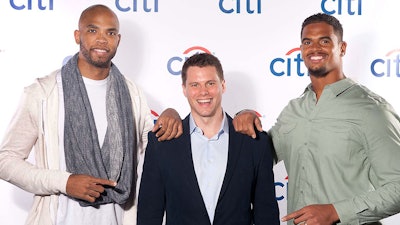 Chicago Bull's Taj Gibson and Chicago Bears Corey Wootton pose with special guests who receive an instant printed photo.