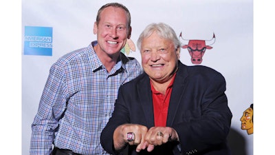 Chicago hero Bobby Hull poses with fans at the American Express sponsored step and repeat Chicago Blackhawks United Center celebrity meet and greet photo activity with onsite 5x7 prints.