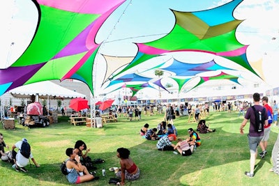 Attendees lounged under shade structures at the festival.